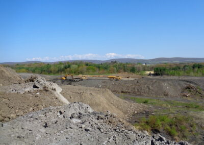 Heavy equipment working to grade large area of uneven land