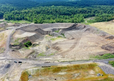 Aerial view of rectangular property with uneven topography partly reclaimed