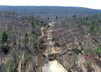 Aerial view of Espy Run stream flowing down through wooded area from Hanover Reservoir.